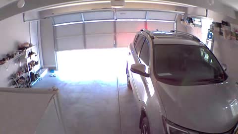 Car Backs into Garage Door Before It's Fully Open