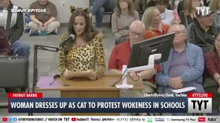 Woman dresses up as a cat to protest against wokeness in schools.