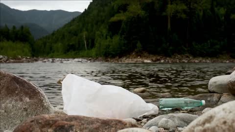 mountain river with rocks and plastic garbage from tourists iroi junk in water creek