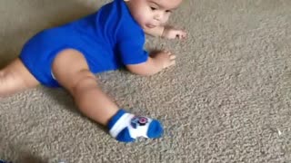 Baby Boy Spins Around Floor Chasing His Foot