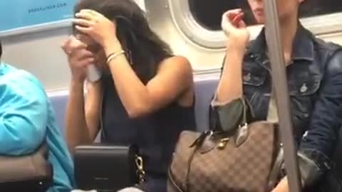 Woman sprays her hair on train