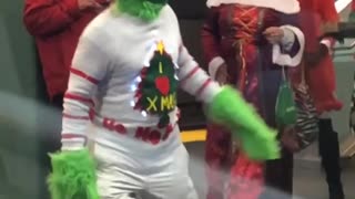 Man dressed as grinch white sweater