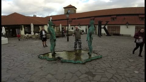 British idiot drinks from the Piss Statue, Prague