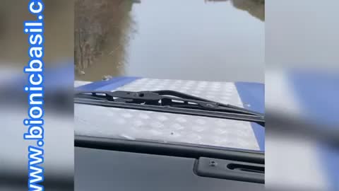 Land Rover Driving Through Flood Water Near River Trent