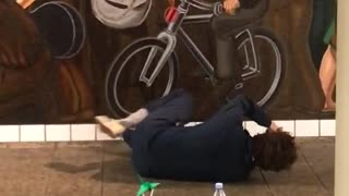 Man with towel on face bumps into wall