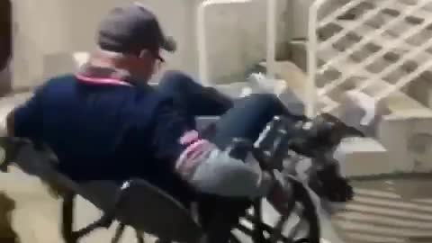 Guy riding wheelchair and falling down
