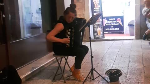 Girl plays amazing accordion song on the street!
