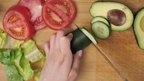 Top view of a woman slicing vegetables