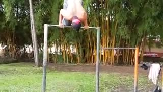 Fit guy blue jeans pull up handstand fail hits pole