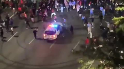 Cops watch helplessly as street racers do donuts around their cruiser outside Philadelphia City Hall