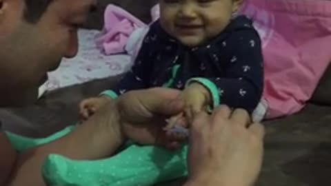 Dad playing with his cute and funny baby