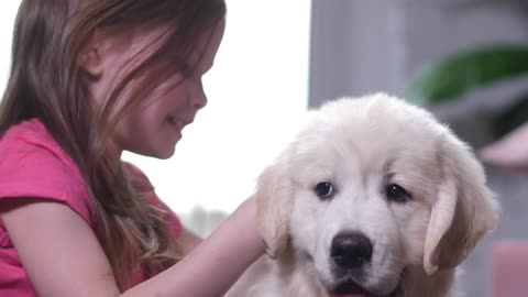 Little girl lovingly hugging her dog