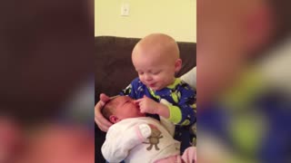 Tot Boy Tries To Pick His Newborn Sister's Nose Repeatedly