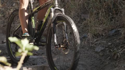 Person cycling down a rocky slope