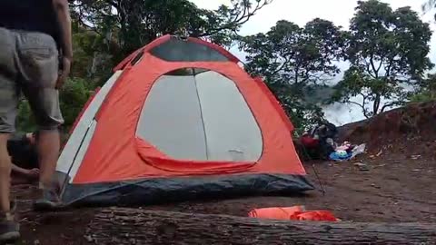 the process of setting up a tent on the mountain