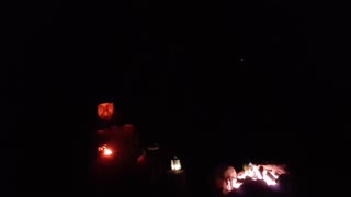 Putting a lantern in shot for filming a campfire vlog