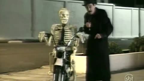 Brazilian Pranks - Skull Rides a Bike front a Cemetery