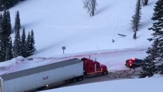 Police Car Pulls Truck Along Icy Road