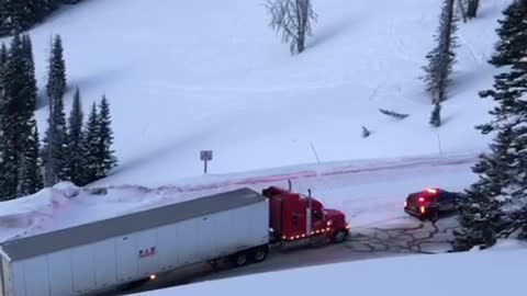 Police Car Pulls Truck Along Icy Road