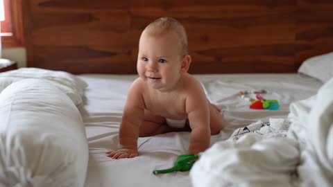 Baby playing on the bedroom