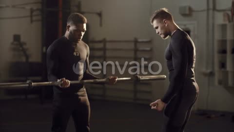 A man lifting weights with trainer instructions