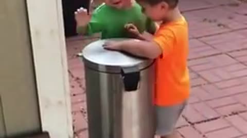 Kids Jokingly Hit Each Other With Trash Can's Lid by Stepping on It's Pedal