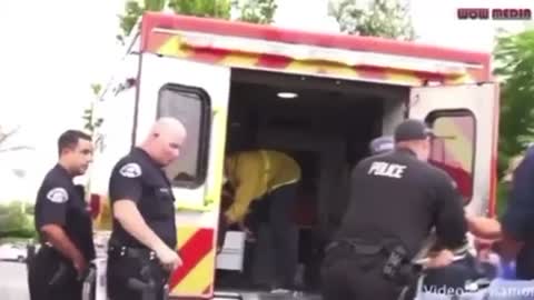 Cop punches guy while hes in stretcher