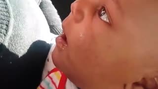 Baby laughs at mother blowing bubble with gum