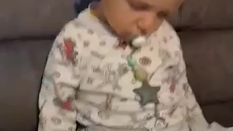 a small child sleeps from sitting
