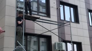 Workers Save Cat From Third-Story Window Fall