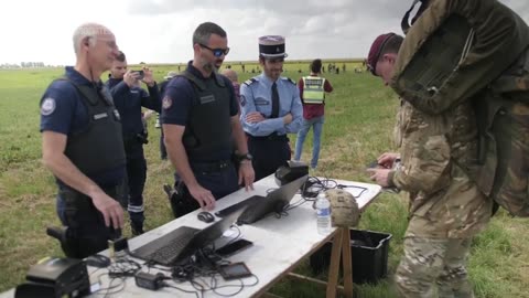 British paratroopers have passports checked after parachuting into France for D-Day event