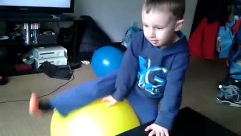 Boy sits pops yellow balloon cries