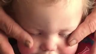 Grandpa gives baby relaxing face massage