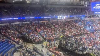 Watching people fill seats in the Trump rally.