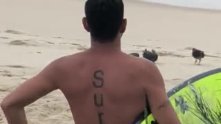 Guy highlight yellow surfboard surf tattoo on back