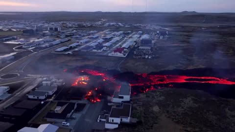 Drone footage of molten lava burning Iceland houses