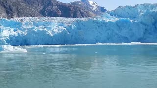 Massive Glacier Calving creating huge blue ice wall