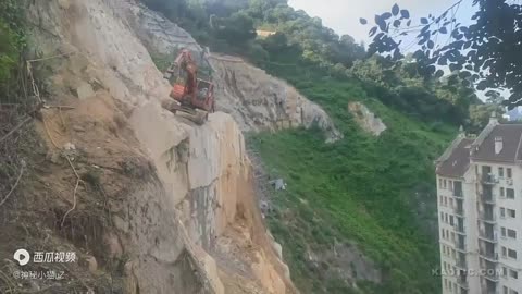 Excavator falls off a cliff