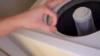 Guy drops tide pod into washing machine circle finger trick