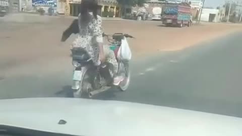 A girl riding a bike with free handed