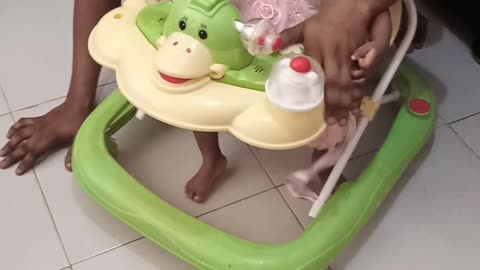 Dad and daughter having fun on a walker.
