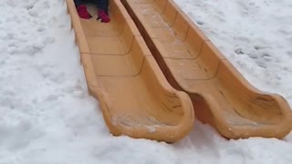 Guy black jacket falling down slide in slomo