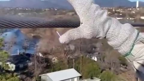 Man grabbing high voltage electric cable