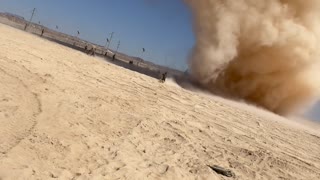 Men Run Toward Massive Dust Devil