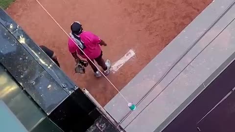 Fan uses a string and a cup to catch a baseball.