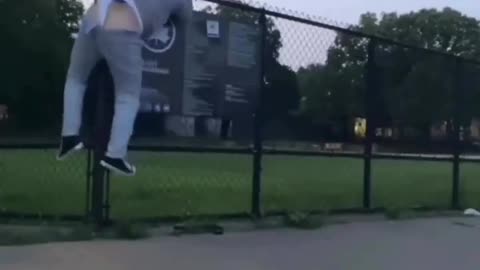 Guy's underwear gets caught trying to jump a fence