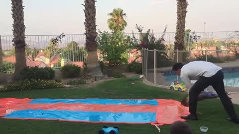 Kid Zooms Across Slip n Slide