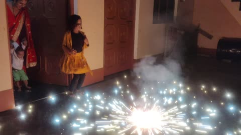 Cute baby enjoying with fire crackers