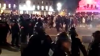 One of macron's minions throws a gas grenade straight off the head of a protester in Paris.