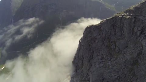 Tourists witness cliff skimming wingsuit flight